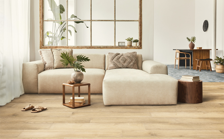 warm toned hardwood flooring in living room with natural decor.